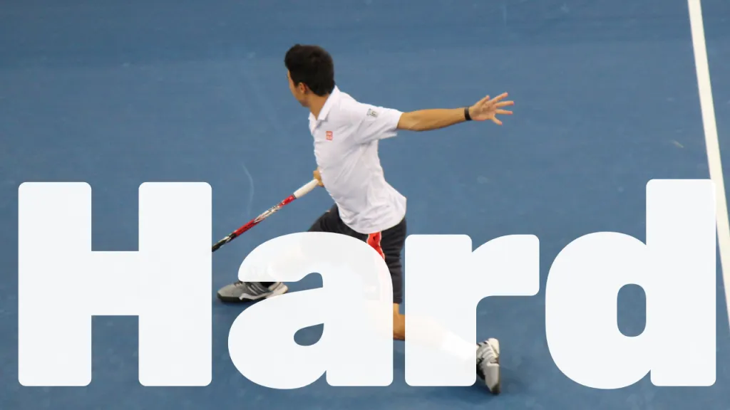 Hard court tennis surface showing the blue acrylic playing area