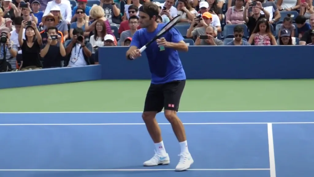 Roger Federer hitting a volley with his racquet head in line with his back shoulder.