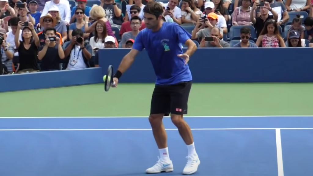 here roger federer is trying to hit volleys and it appears it's a good volley without having a big backswing. in this more advanced version of a volley his non dominant hand to his side and not yet behind him.